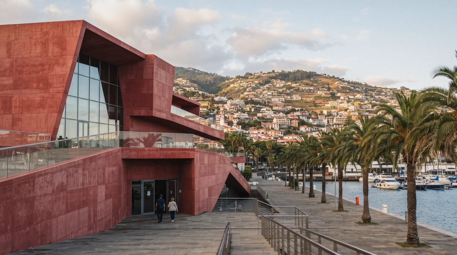 The modern red concrete facade of the CR7 Museum near the marina in Funchal, Madeira, Portugal