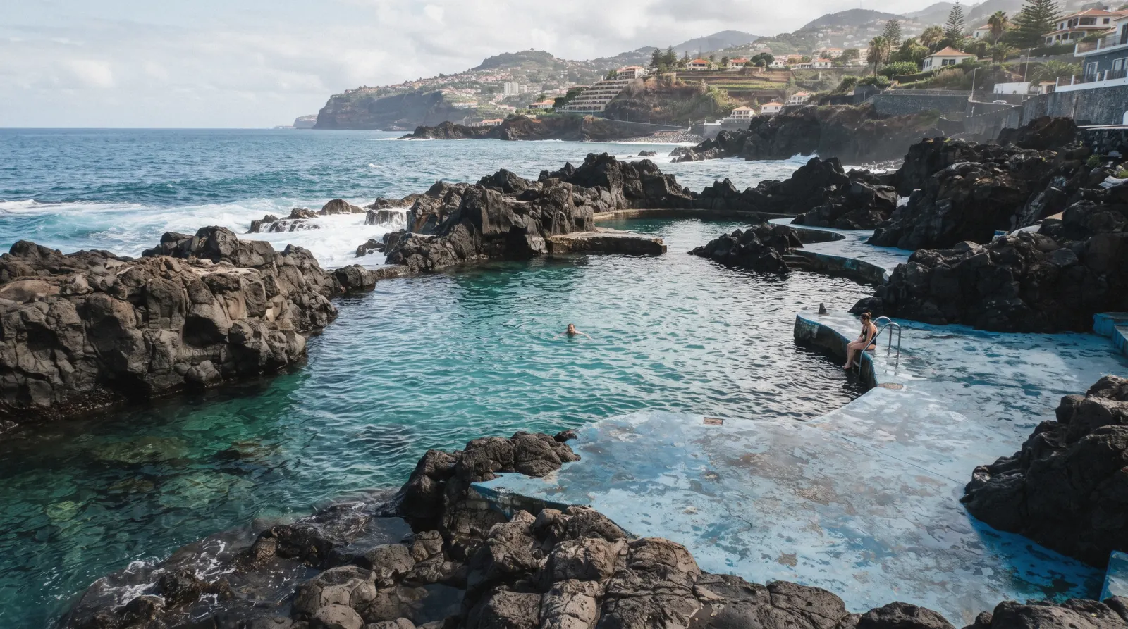 The natural volcanic-rock swimming pools of Doca do Cavacas bathing complex on the coast of Funchal, Madeira, Portugal