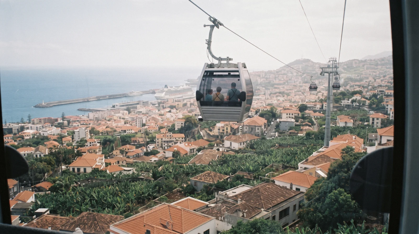 A cable car cabin above the rooftops on the 18 minute ride from the old town up to Monte in Funchal, Portugal