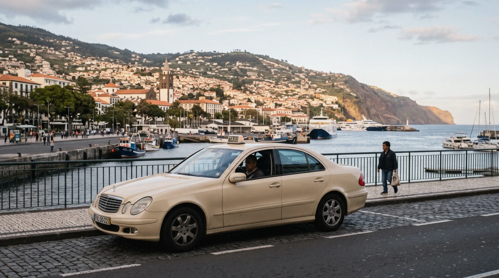 A taxi waiting at a rank on Avenida do Mar in Funchal with the harbour behind, a Funchal taxi