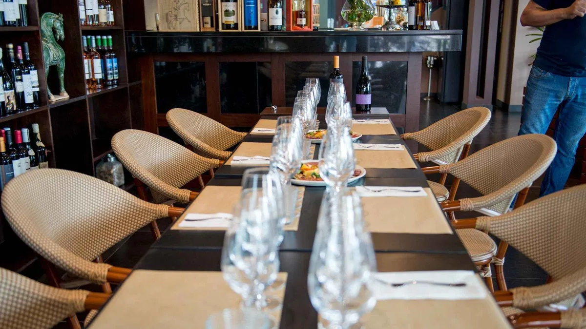 Five glasses of aged Madeira wine lined up for a tasting with cheese and dried fruit on a Madeira wine tasting with sommelier in Funchal, Portugal