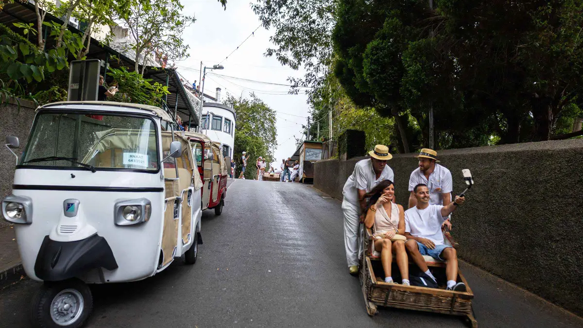A tuk-tuk parked near the Monte toboggan rank above Funchal on a guided tuk tuk tour to toboggan rides and old town in Monte, Madeira