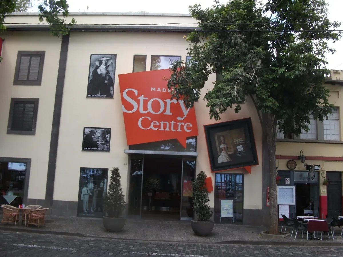 The red Madeira Story Centre sign and entrance on Rua D. Carlos I in the old town of Funchal, Portugal