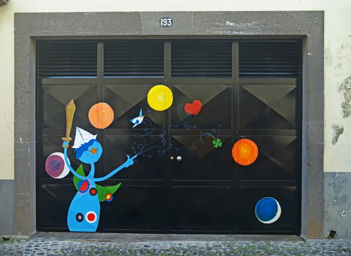 A painted door at Rua de Santa Maria 193 in the old town of Funchal, Portugal, part of the open doors art project