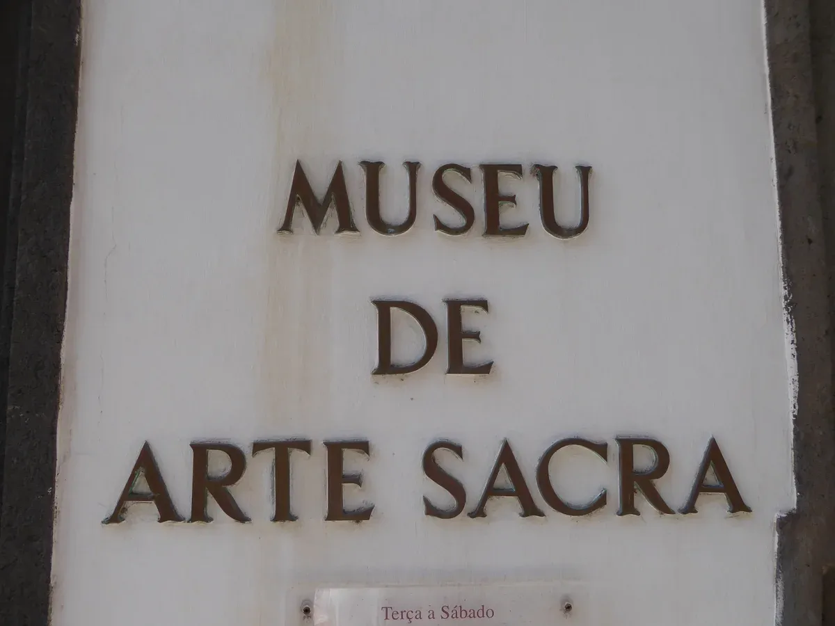 The carved stone sign reading Museu de Arte Sacra above the entrance of the Sacred Art Museum in Funchal, Madeira, Portugal